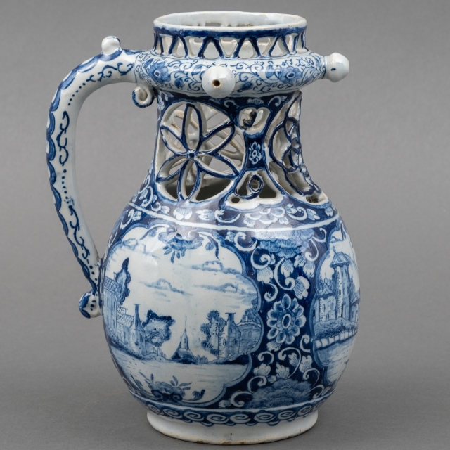 Delft earthenware fap jug with openwork neck and blue-white landscape decor, marked, executed by De Lampetkan, first half 18th century, height 21 cm